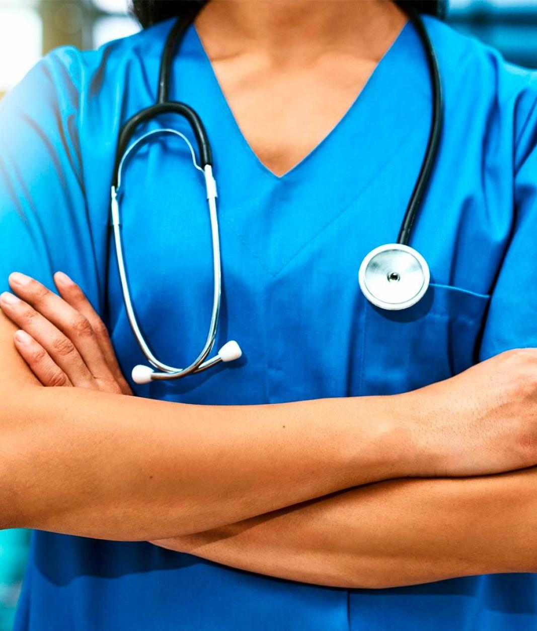 medical professional standing with arms crossed