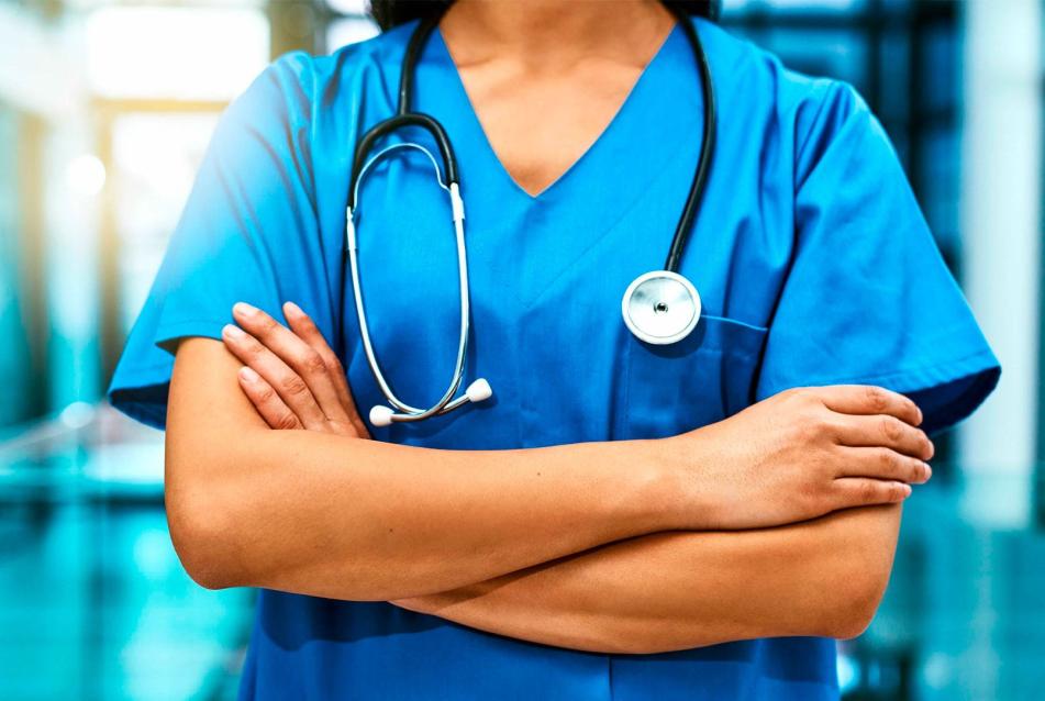 medical professional standing with arms crossed